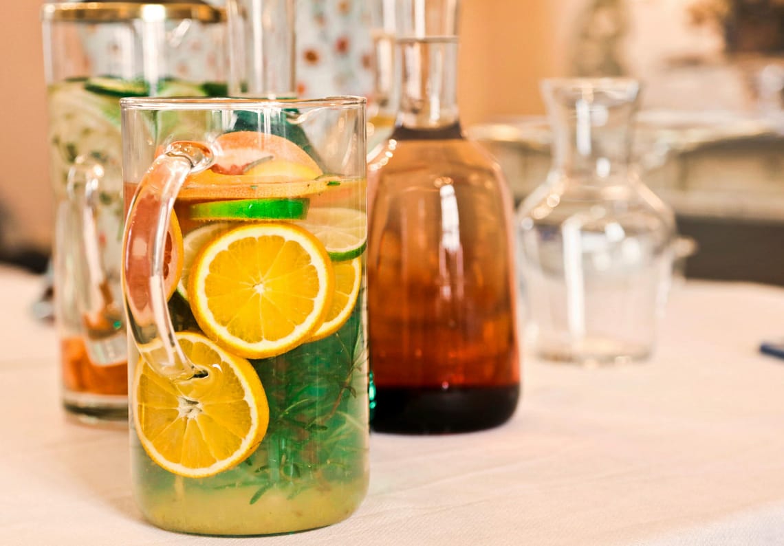 Colorful pitchers of citrus-infused water offer a refreshing beverage choice.