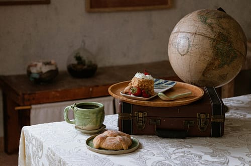 A rustic Chiapas breakfast setting with artisanal ceramics and globe.