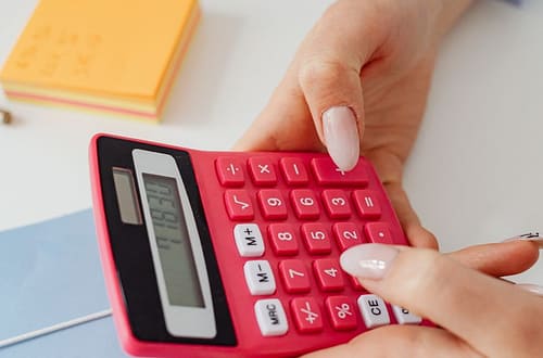 close up shot of a person holding a calculator