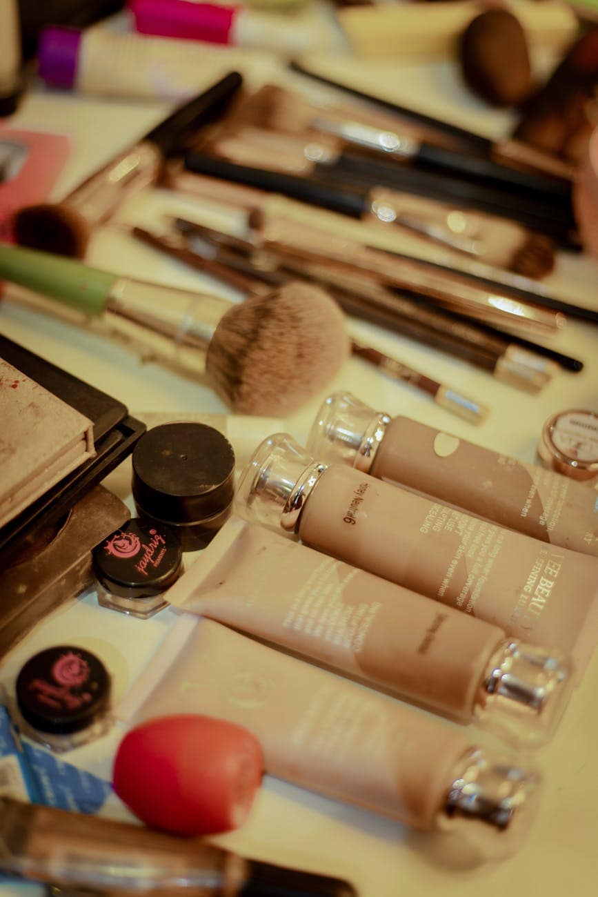 assorted makeup products on dressing table