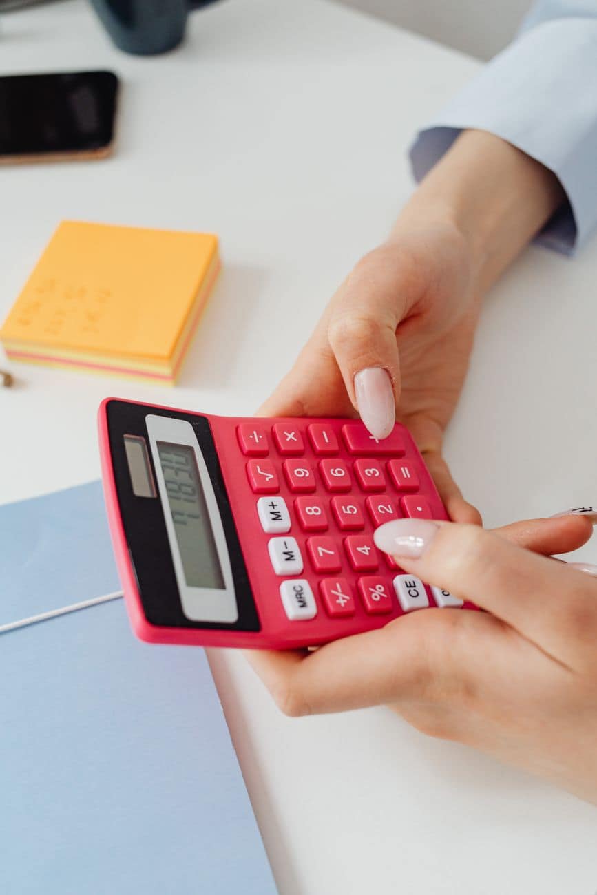 close up shot of a person holding a calculator
